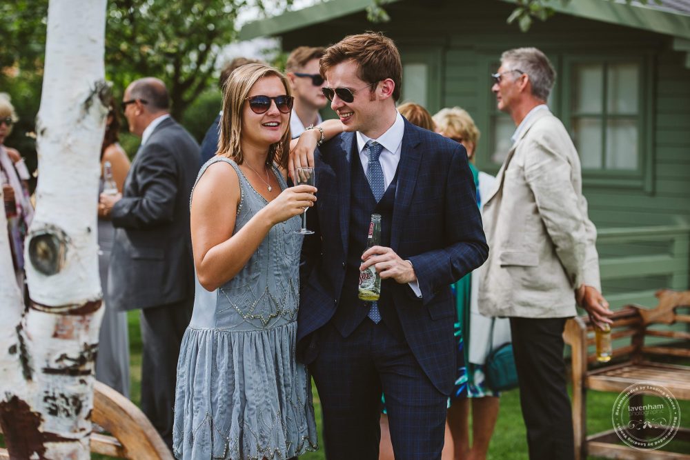 Casual Photography of wedding guests. A couple chat at Channels wedding